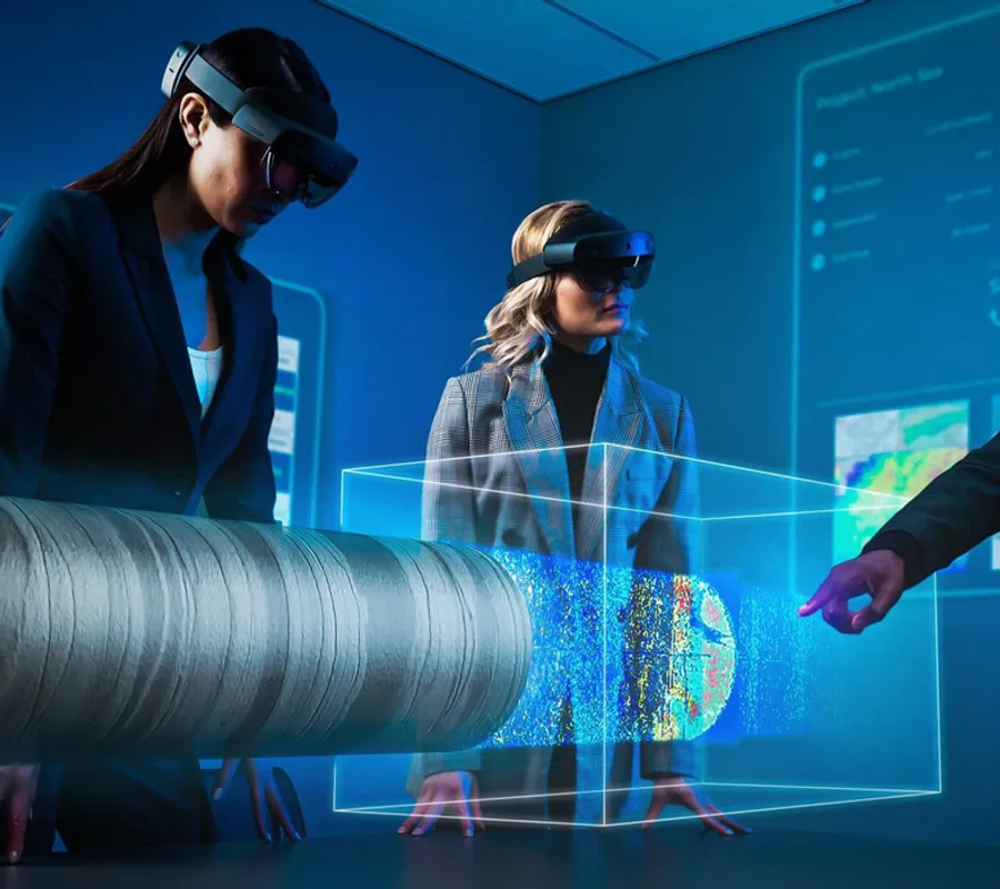 Promotional illustration of a team examining a horizontal core and CT volume using mixed-reality headsets